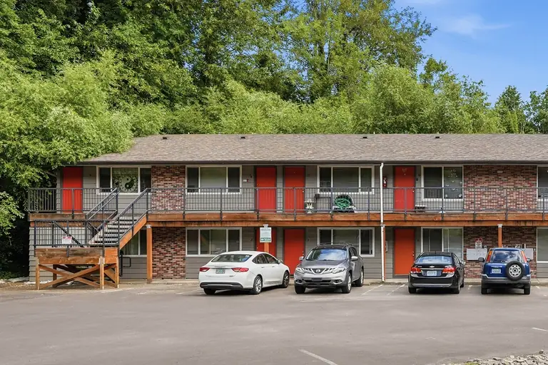 Glen Alden building exterior with parking and trees behind